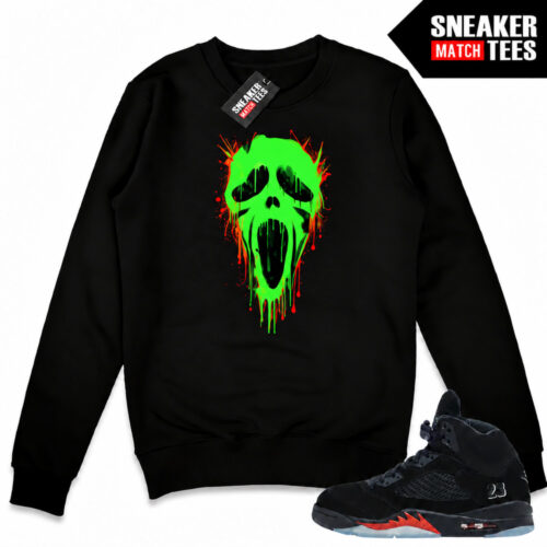 Black Halloween 5s crewneck sweatshirt with a green-glow Ghostface front graphic, orange accents, and matching Air Jordan 5 sneakers