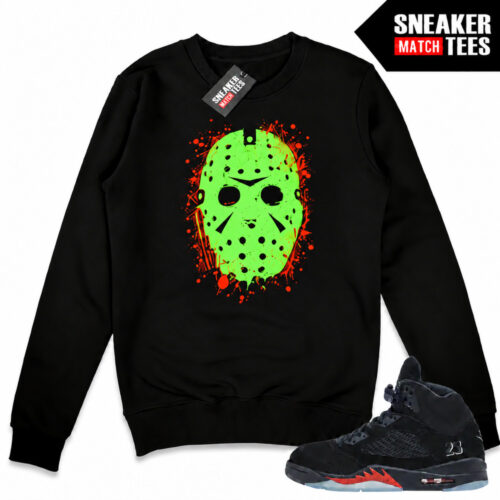 Black Halloween 5s crewneck sweatshirt with a green-glow Jason Voorhees hockey mask front graphic, orange accents, and matching Air Jordan 5 sneakers